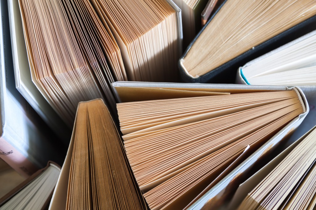 Old and used hardback books seen from above